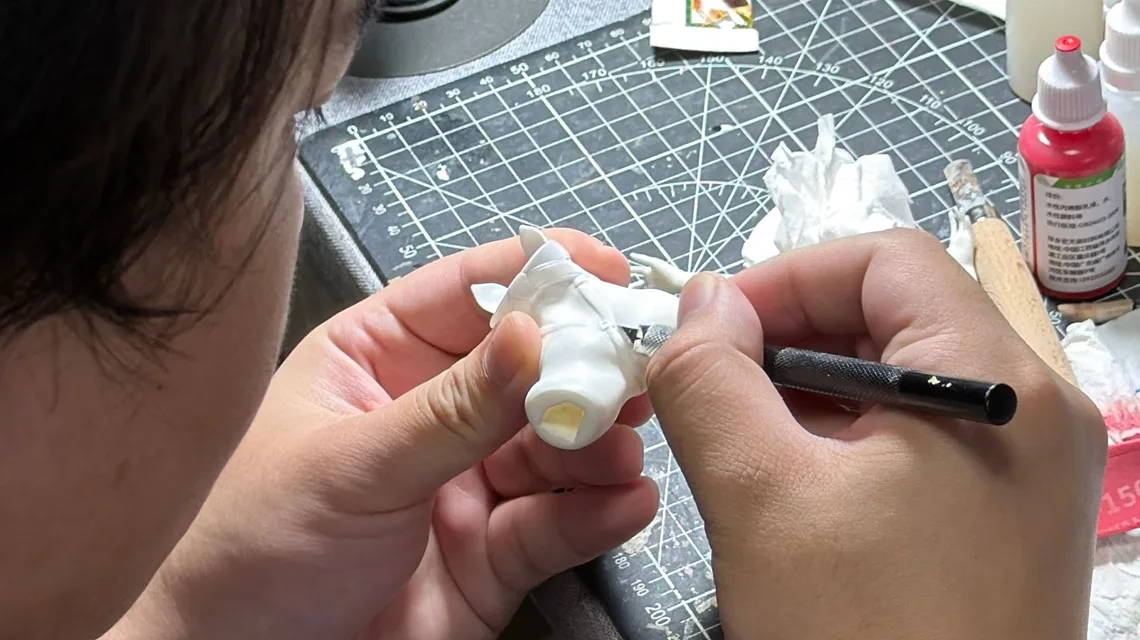 Craftsman refining the printed prototype by hand